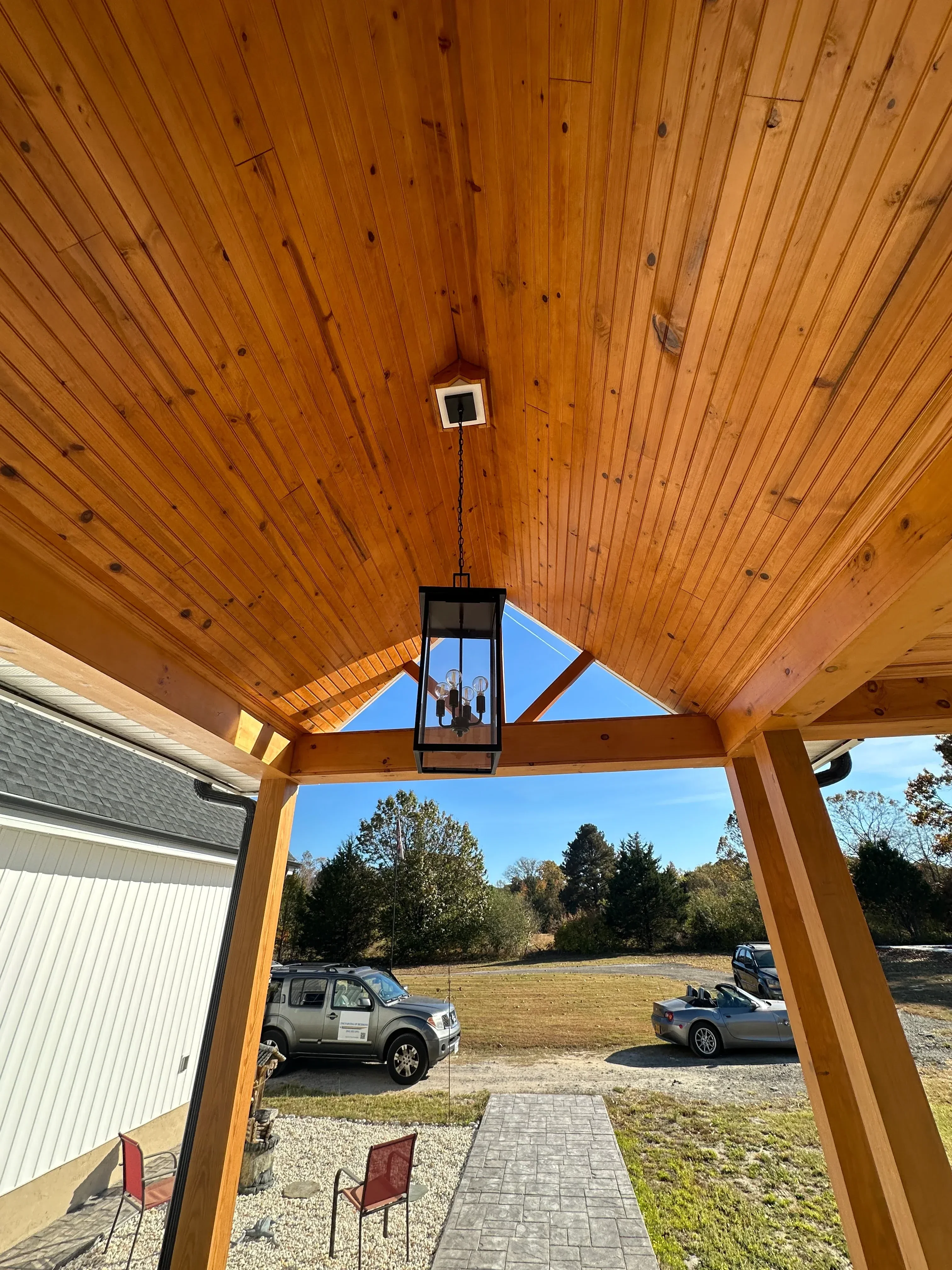 Cedar deck with horizontal decking, timber frame pergola, and electrical outlet installation