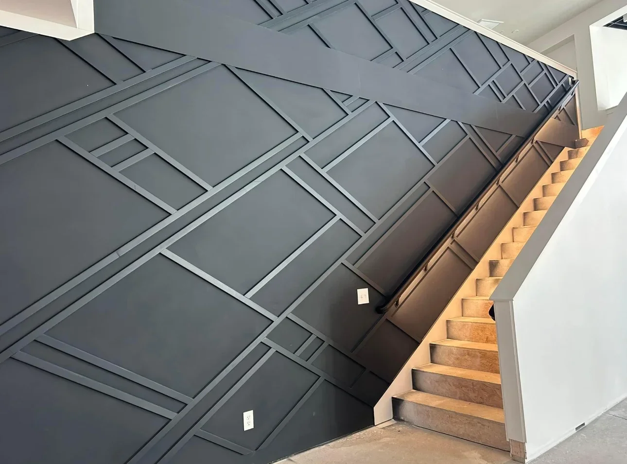 Charcoal gray coffered ceiling with geometric panel pattern and white trim detail