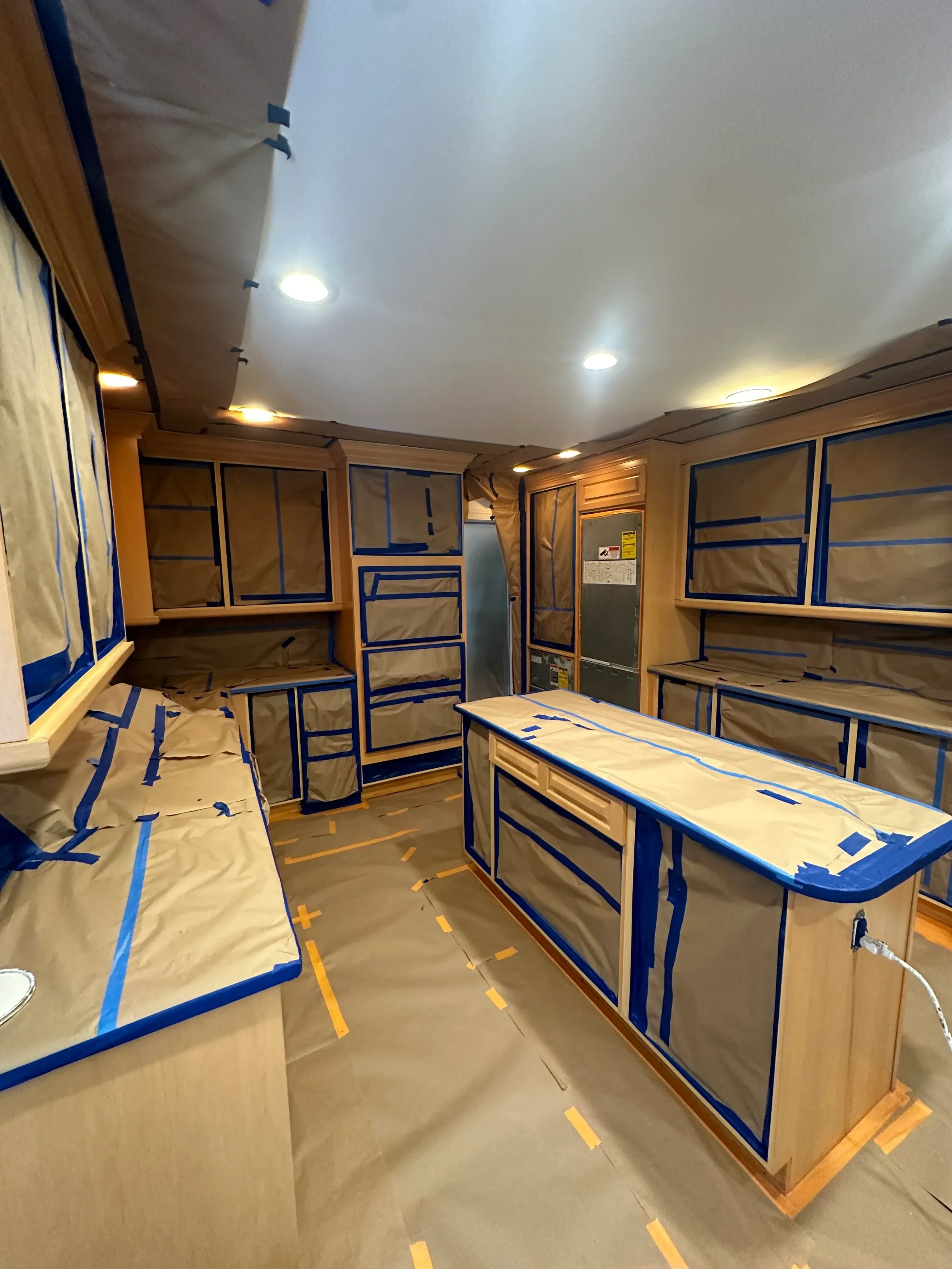 Interior drywall taping, mudding, and painter's tape protection on trim and fixtures